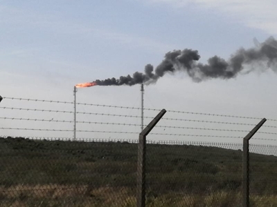 Thick, grey smoke from PetroSA flare stack