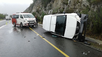 Bakkie and car collide on wet pass