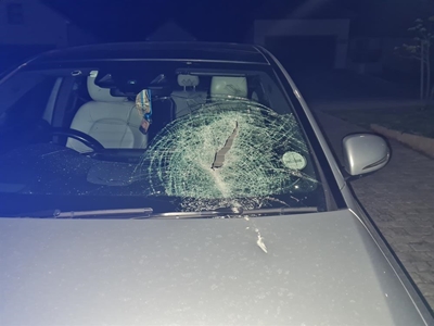 Narrow escape as brick hits car