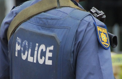 Naked man hits police officer over the head with a brick