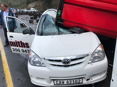 Lucky to be alive after truck overturns on car