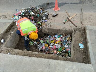 Illegal dumping in stormwater infrastructure leads to flooding and road damage