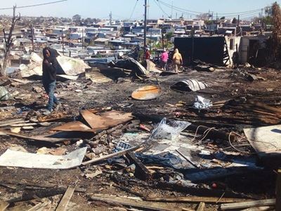Call for help after fire razes 32 dwellings