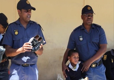 Police donate school shoes to children