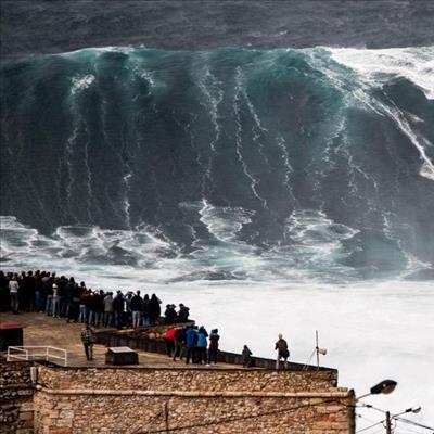 Surfer breaks back riding big wave