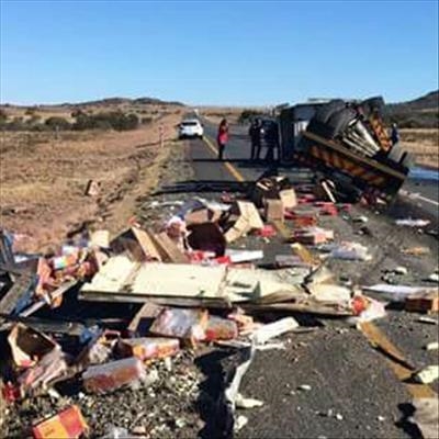 Locals help driver escape overturned truck