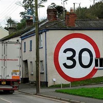 Homeowner paints 15ft high 30mph sign on side of property 