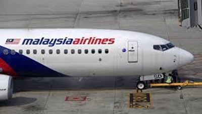 Malaysia observes day of mourning as MH17 victims return home