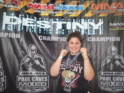Local fighter wins triple gold