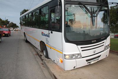 Bus lands in manhole