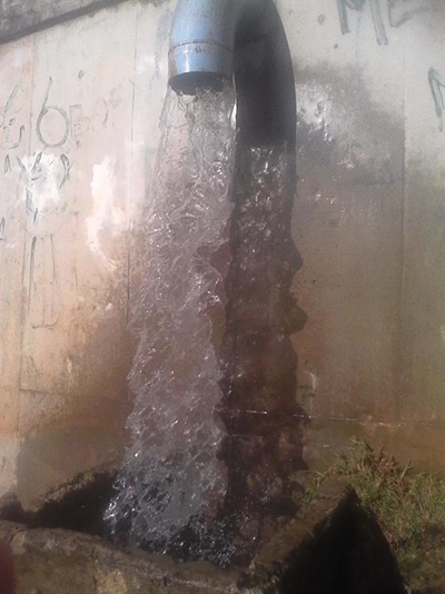 Flooding water pours into home
