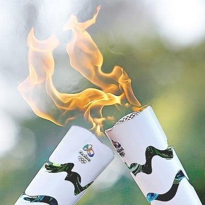 Torch surfs its way into Rio as protests hit ahead of Olympics