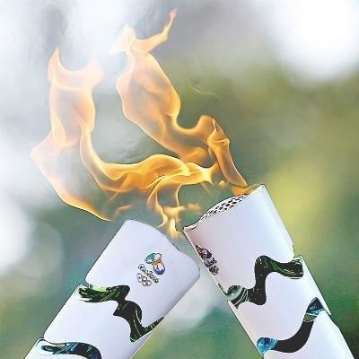 Torch surfs its way into Rio as protests hit ahead of Olympics